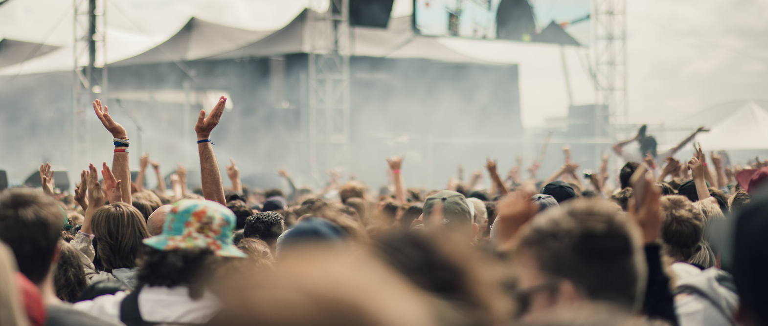 A crowd have fun at a music festival.